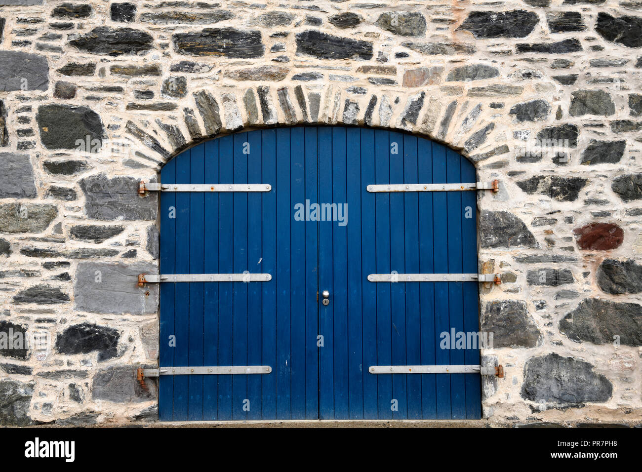 Blue door on stone house at Old Harbourside Portsoy Aberdeenshire Scotland UK Stock Photo
