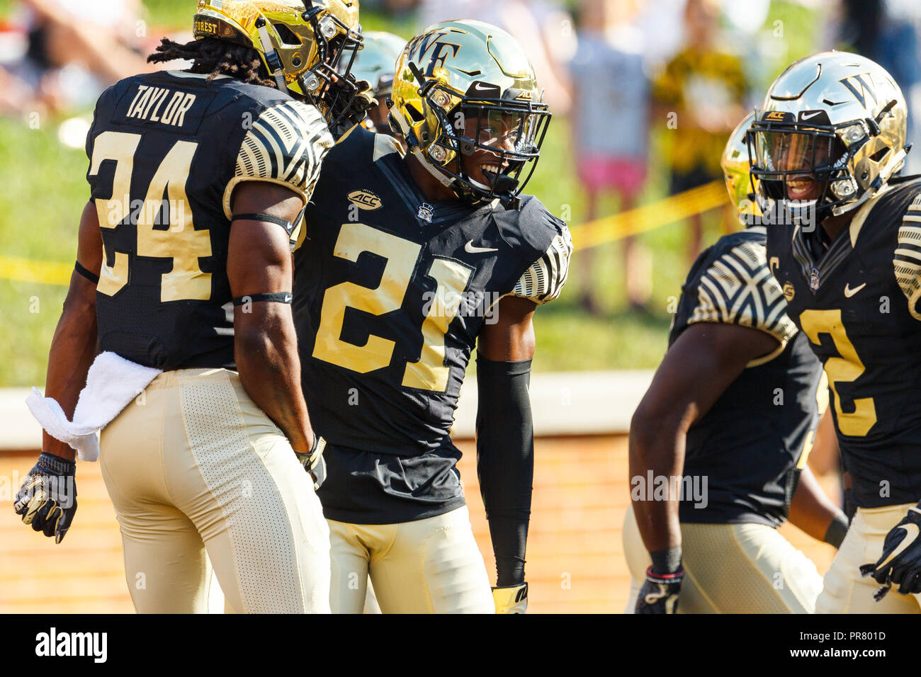 Winston-Salem, NC, USA. 29th Sep, 2018. Wake Forest Demon Deacons defensive  back Essang Bassey (21) celebrates his touchdown with defensive back Ja'Sir  Taylor (24) and defensive back Cameron Glenn (2) in the