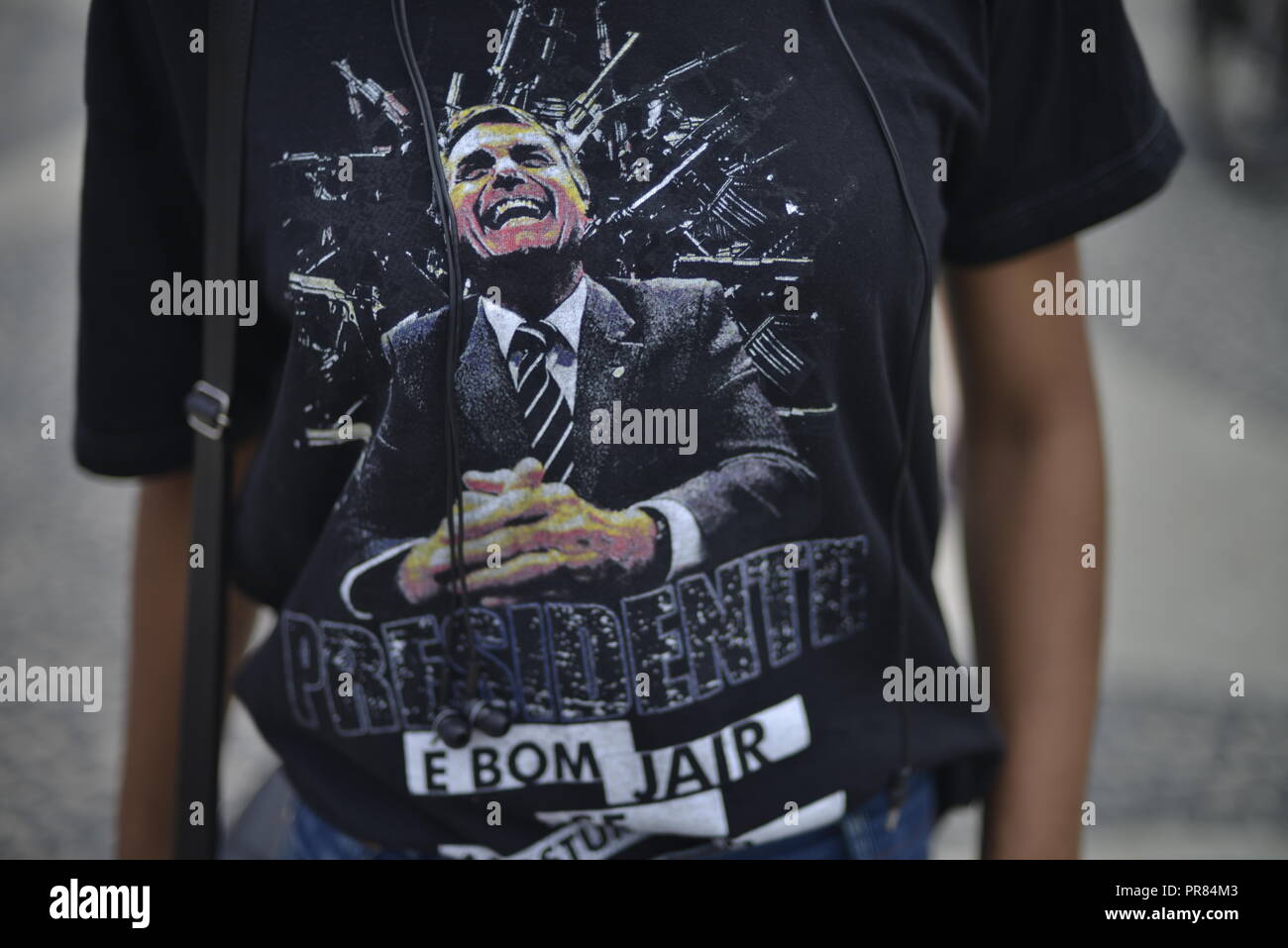 Rio de Janeiro, Brazil. 29th Sep, 2018. A supporter of the ultra-right presidential candidate Bolsonaro is wearing a T-shirt with his picture on it at a rally. The ex-military rants against homosexuals and blacks and glorifies the military dictatorship (1964-1985). Again and again he shocks with derailments. He once certified to a politician that she did not deserve to be raped "because she is very ugly". Credit: Fabio Teixeira/dpa/Alamy Live News Stock Photo