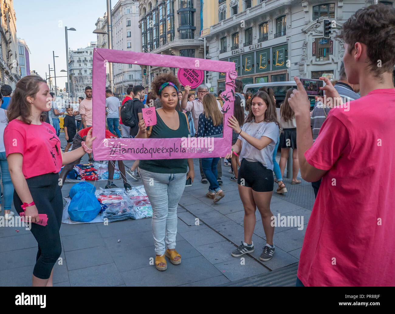 Madrid, Spain. 30 September 2018. A protest action against slavery in fashion industry took place in Gran Vía, the main street of Madrid, consisting of creating awareness around the explotation of people in fashion factories. The organizators gave passers by pink baloons to explode in front of the main comercial shops of the street. Credit: Lora Grigorova/Alamy Live News Stock Photo