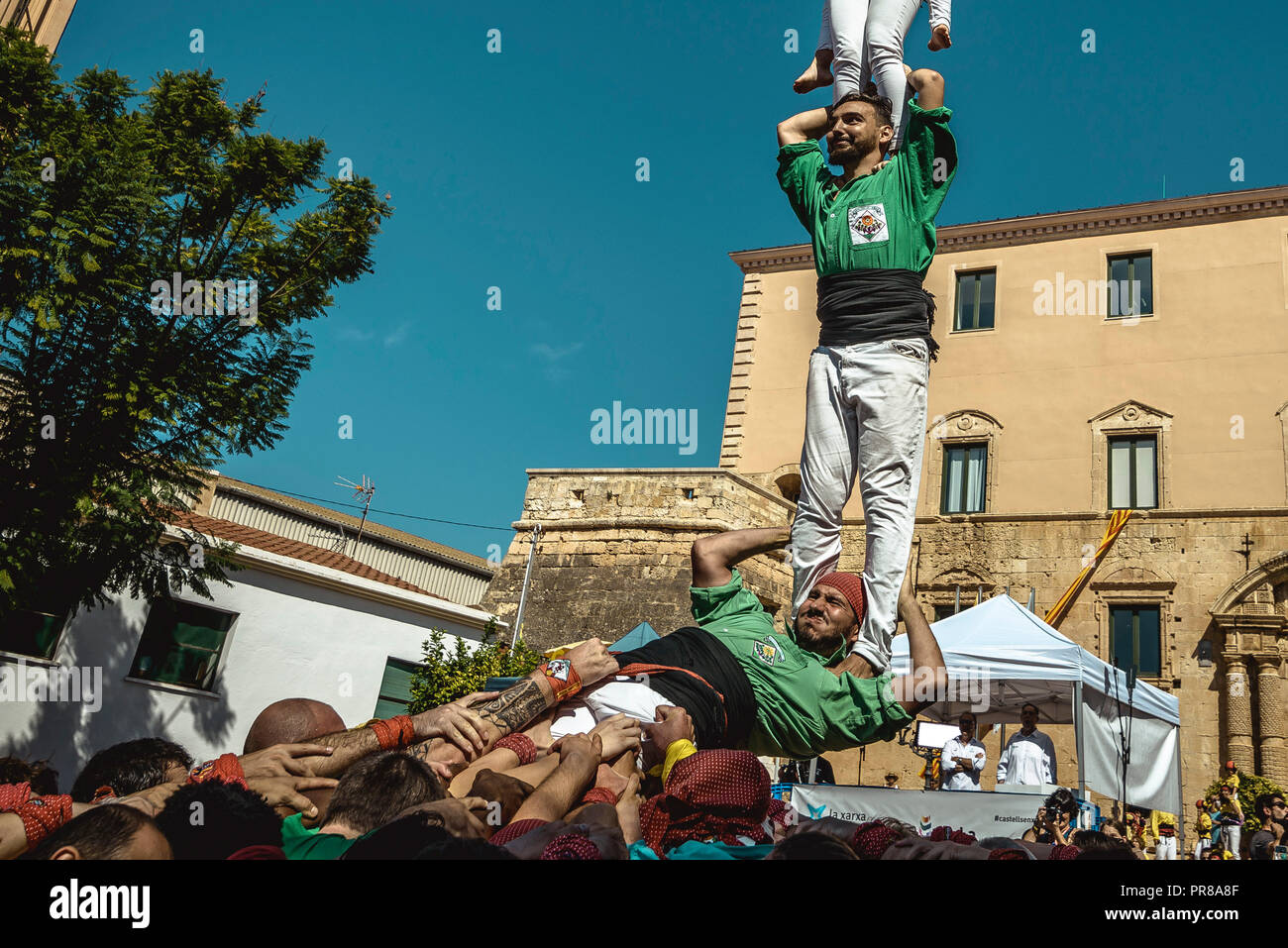 Torredembarra, Spain. 30 September, 2018:  A human pillar of the 'Castellers del Riberal' collapses during the first day of the 27th Tarragona Human Tower Competition in Torredembarra. The competition takes place every other year and features the main 'Castellers' teams (colles) of Catalonia during a three day event organized by the Tarragona City Hall Credit: Matthias Oesterle/Alamy Live News Stock Photo