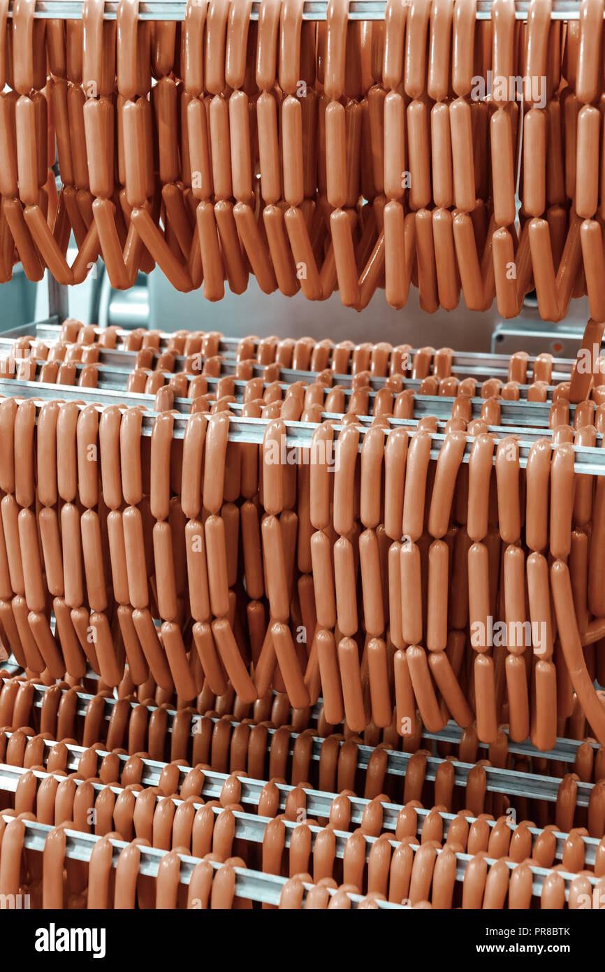 stainless steel rack full with frankfurter sausage Stock Photo