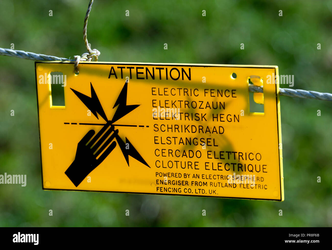 Multi-lingual electric fence sign, UK Stock Photo