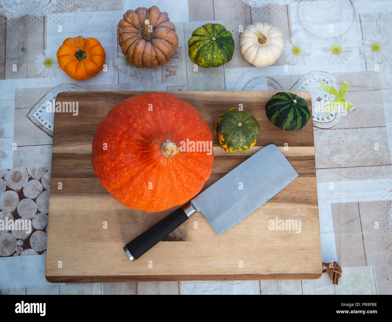 Top down view of imagine with pumpkins and axe on a wooden board Stock Photo