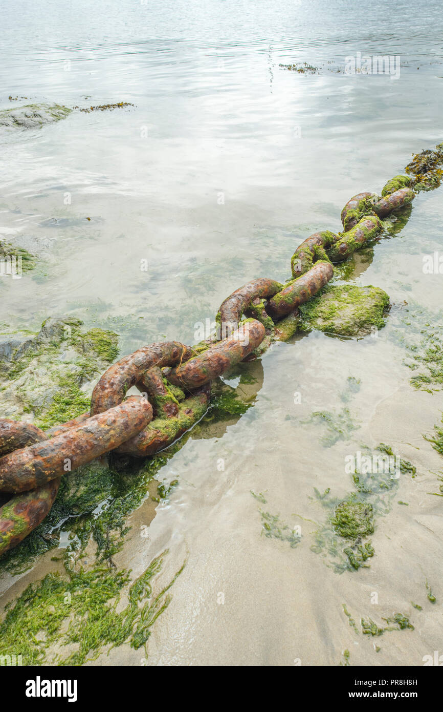 Harbour scenes around Newquay, Cornwall. Very large rusting mooring chain links. Metaphor strong links, strongest link, forge links, close ties. Stock Photo