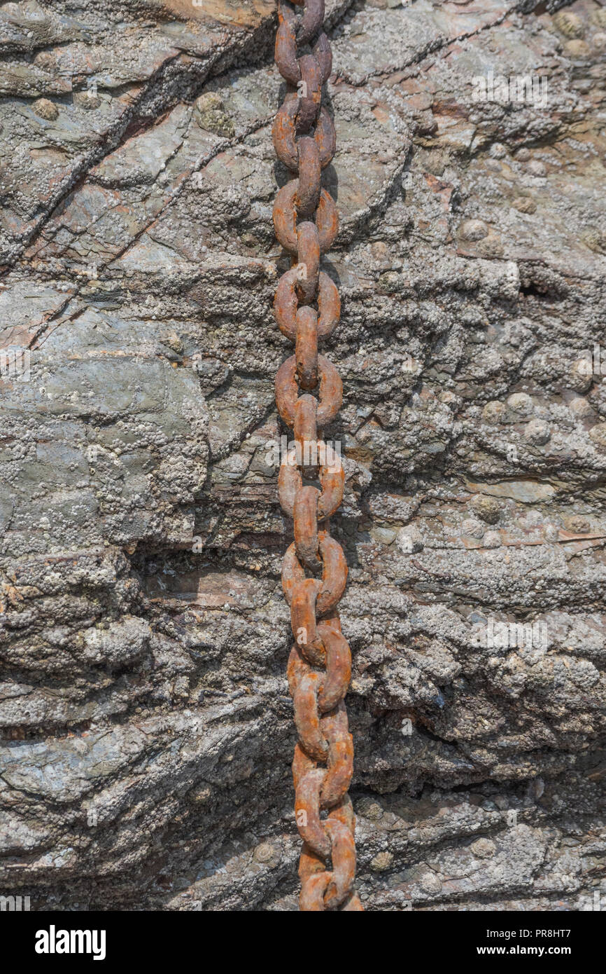 Harbour scenes around Newquay, Cornwall. Rusting mooring chain links. Metaphor strong links, strongest link, forge links, close ties. Stock Photo