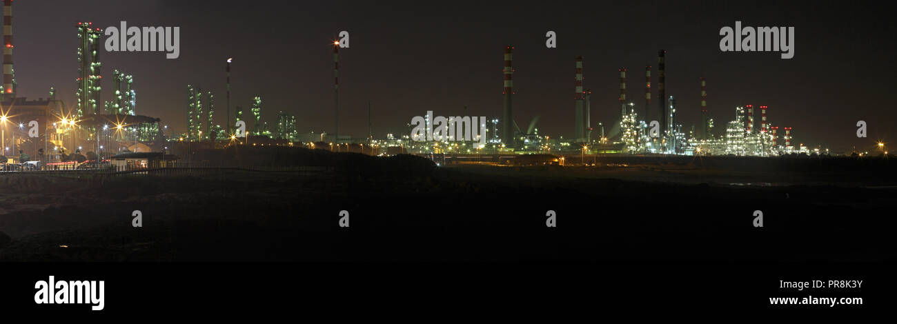 Big oil refinery at night with interesting light - Panorama Stock Photo