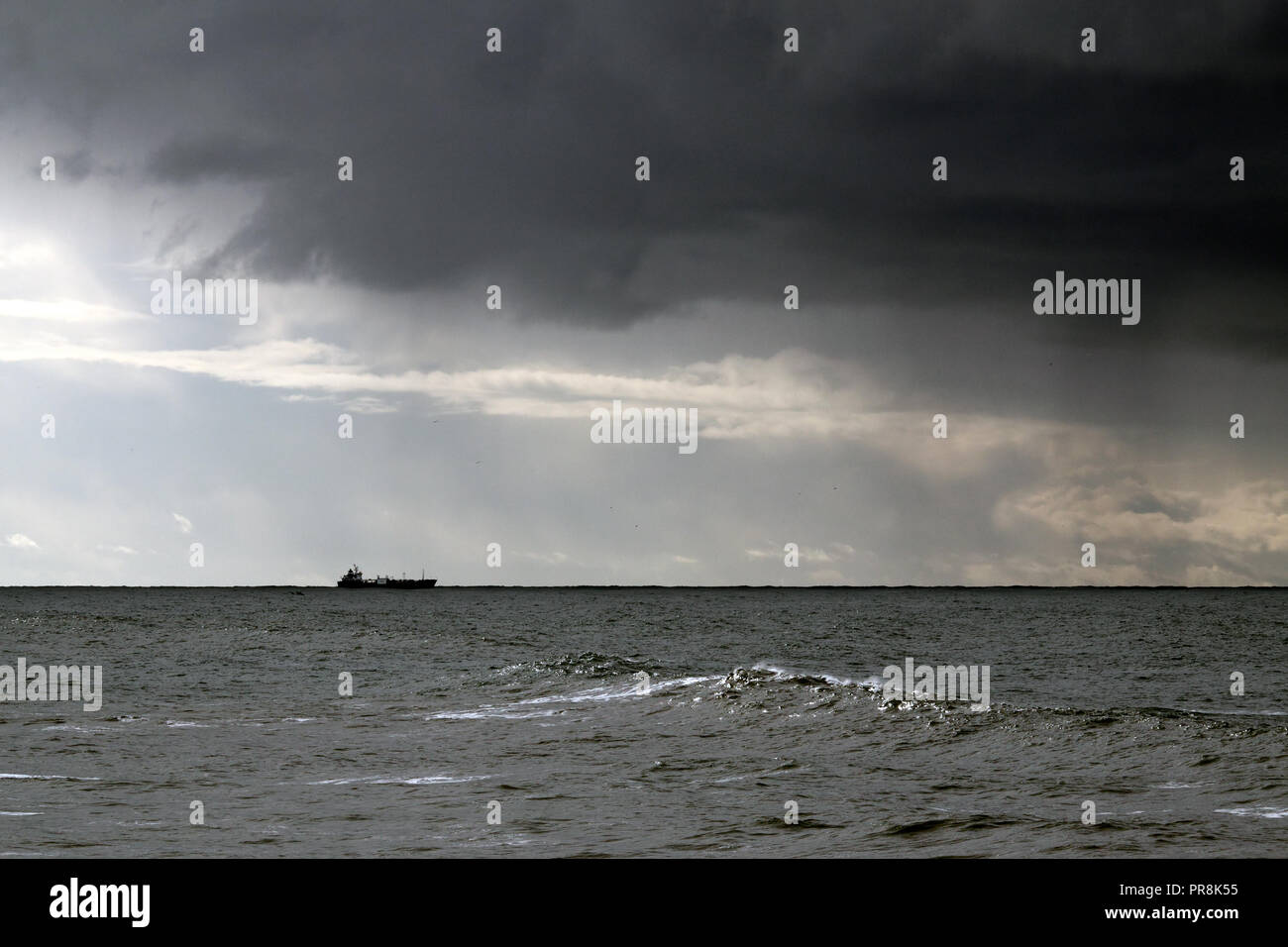Commercial ship in the horizon against blue sky with some clouds Stock ...