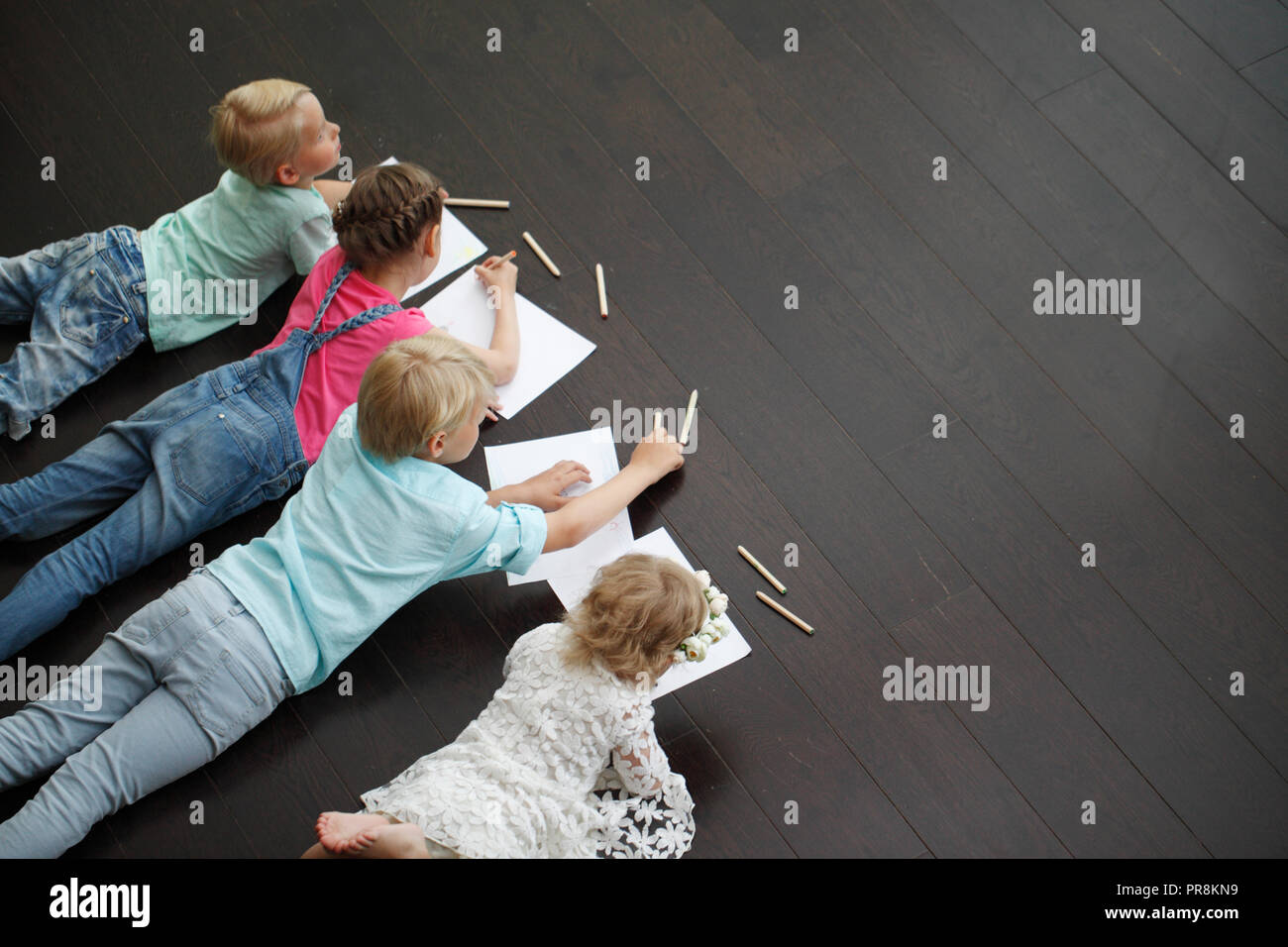 Group of cute children drawing with colorful pencils on floor Stock ...