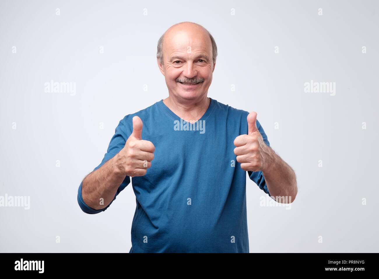 Older man in blue shirt hi-res stock photography and images - Alamy