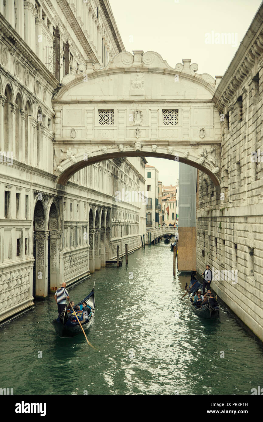 The Bridge of Sighs is a bridge located in Venice, northern Italy. The enclosed bridge is made of white limestone, has windows with stone bars, passes Stock Photo