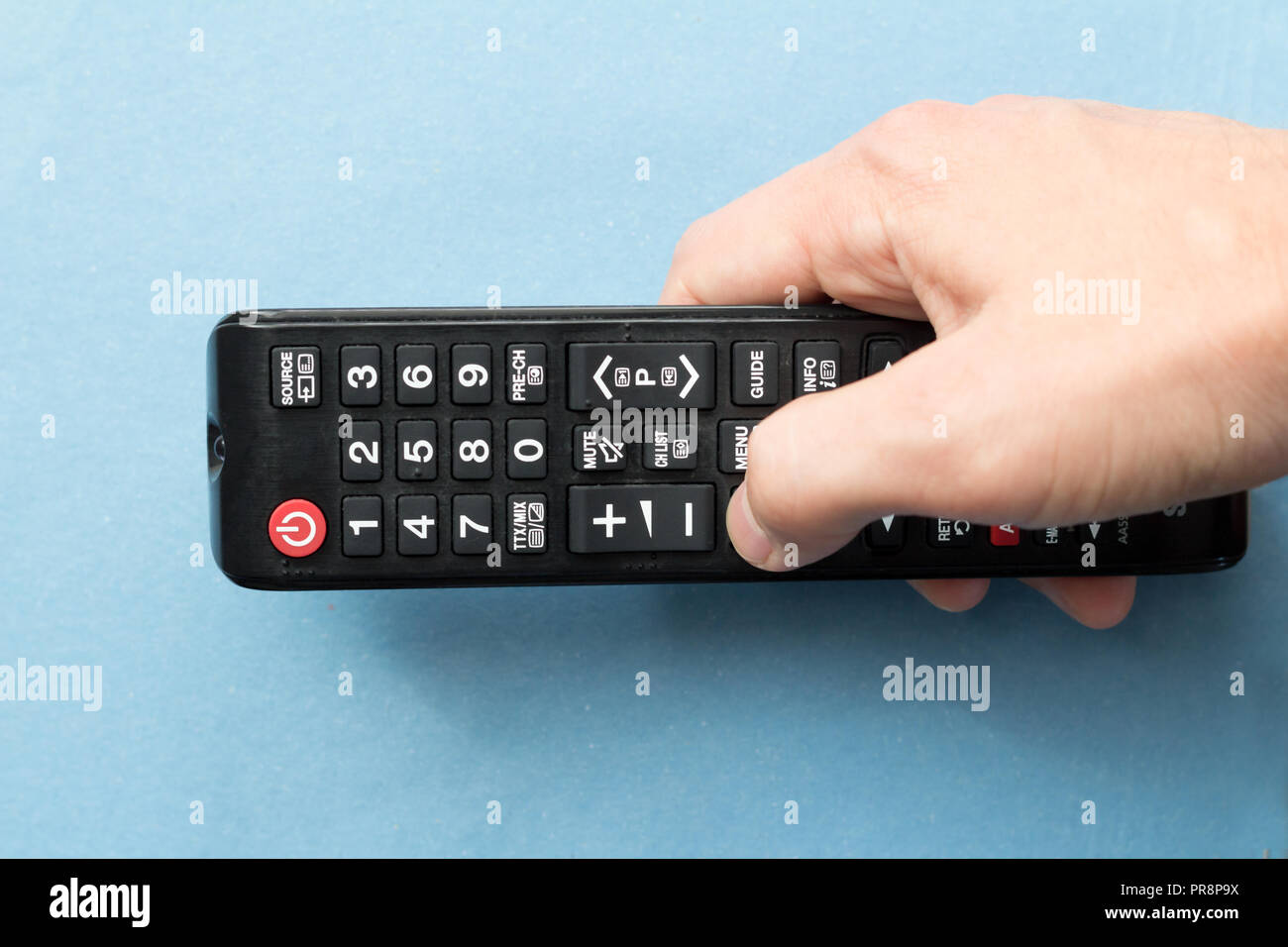 hand holding remote control Stock Photo