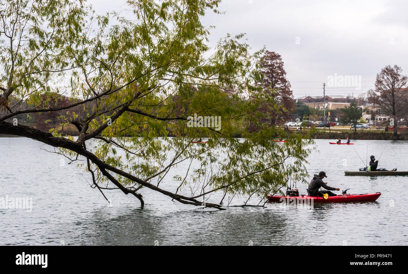 AUSTIN, TEXAS - DECEMBER 30, 2017: People in kayaks fishing on Lady Bird Lake. Stock Photo