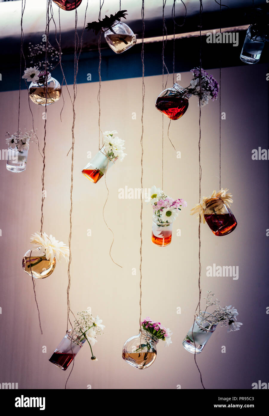 Herbal tea bottles with flowers hanging on strings Stock Photo - Alamy