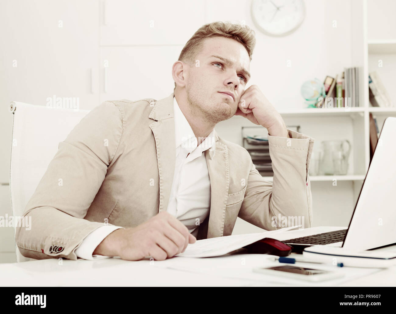 Frustrated young man having business problems with papers at workplace Stock Photo