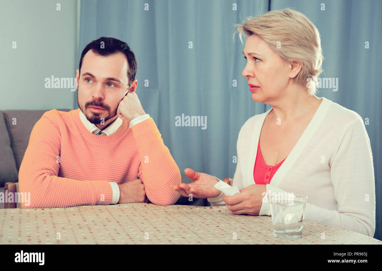 Mature mother and son quarrel and find out relationship Stock Photo