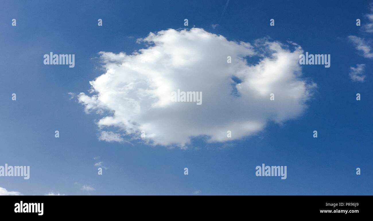 Beautiful clouds against a blue sky background. Cloudscape sky. Blue sky with cloudy weather, nature cloud. White clouds, blue sky and sun. Stock Photo