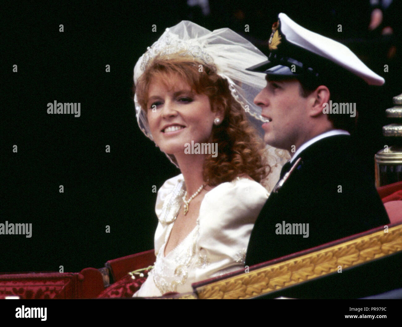 The Duke and Duchess of York (formerly Prince Andrew and Miss Sarah Ferguson) smile happily during their carriage procession after their wedding at Westminster Abbey in London. Sarah, Duchess of York is the archetypal mother of the bride, a larger-than-life character prone to controversy, outspoken and fiercely loyal to her family. Stock Photo