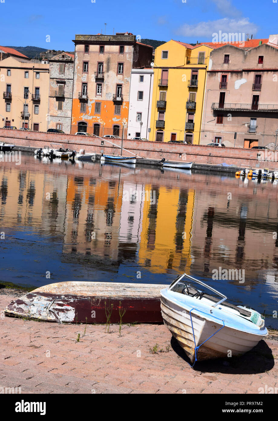 fisching boats in sardinia with cityscape of bosa, panoramic view on the boats on the river temo in Bosa in Sardinia including typical colorful Italia Stock Photo