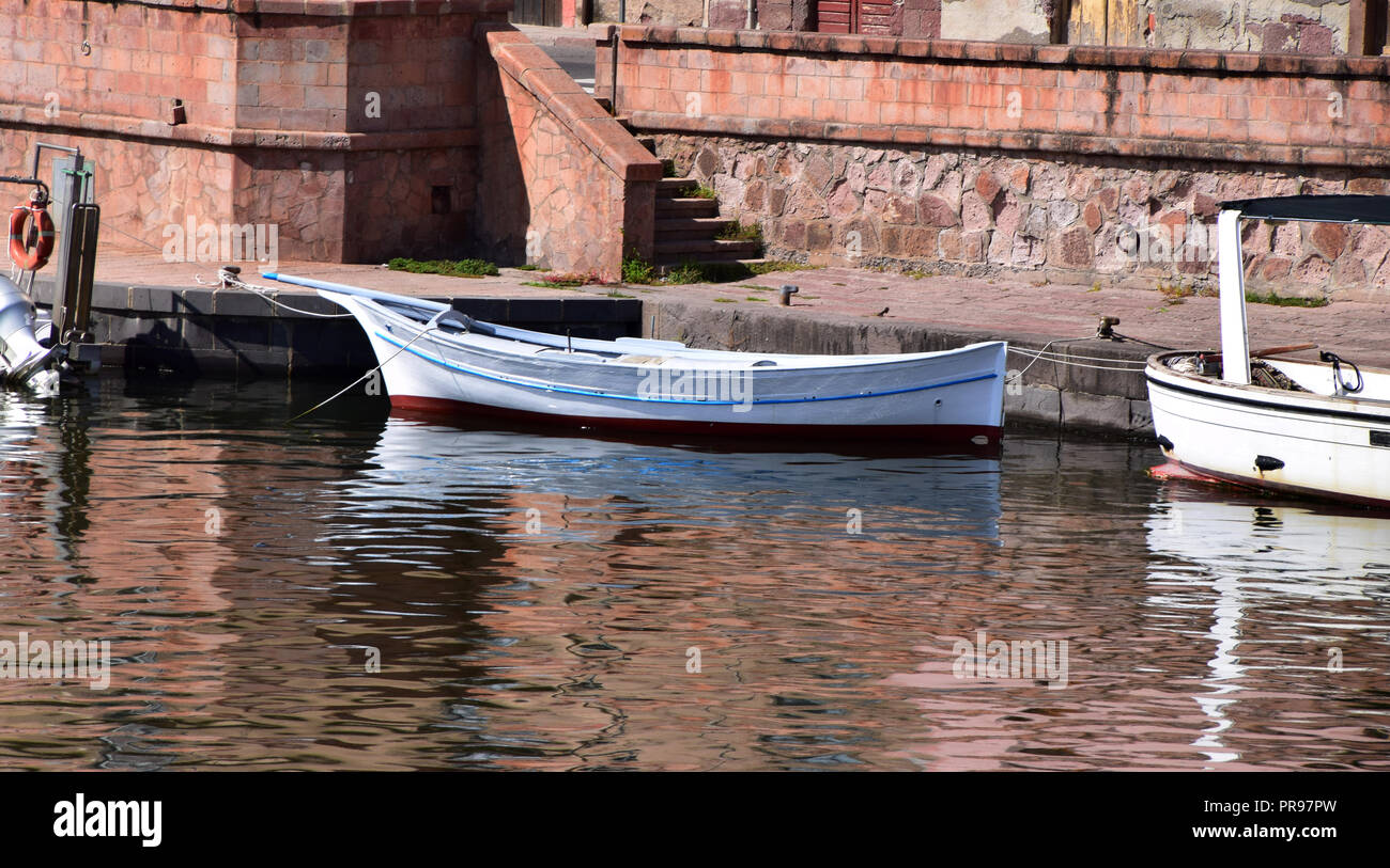 typical small fisching boats in sardinia, panoramic view on the boats on the river temo in Bosa in Sardinia Stock Photo