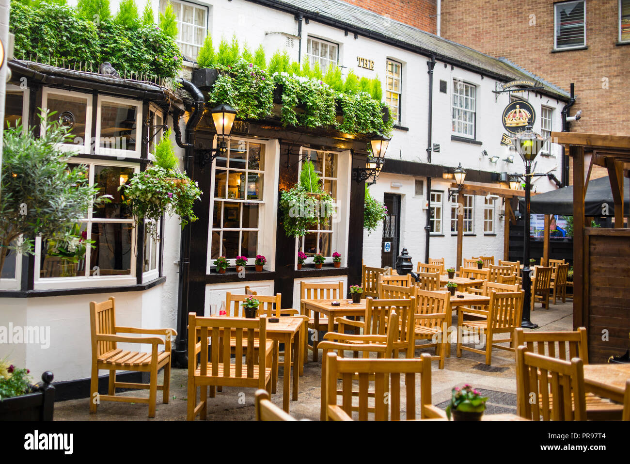 The Crown pub in Oxford, England has an outdoor courtyard and historical charm inside. Stock Photo