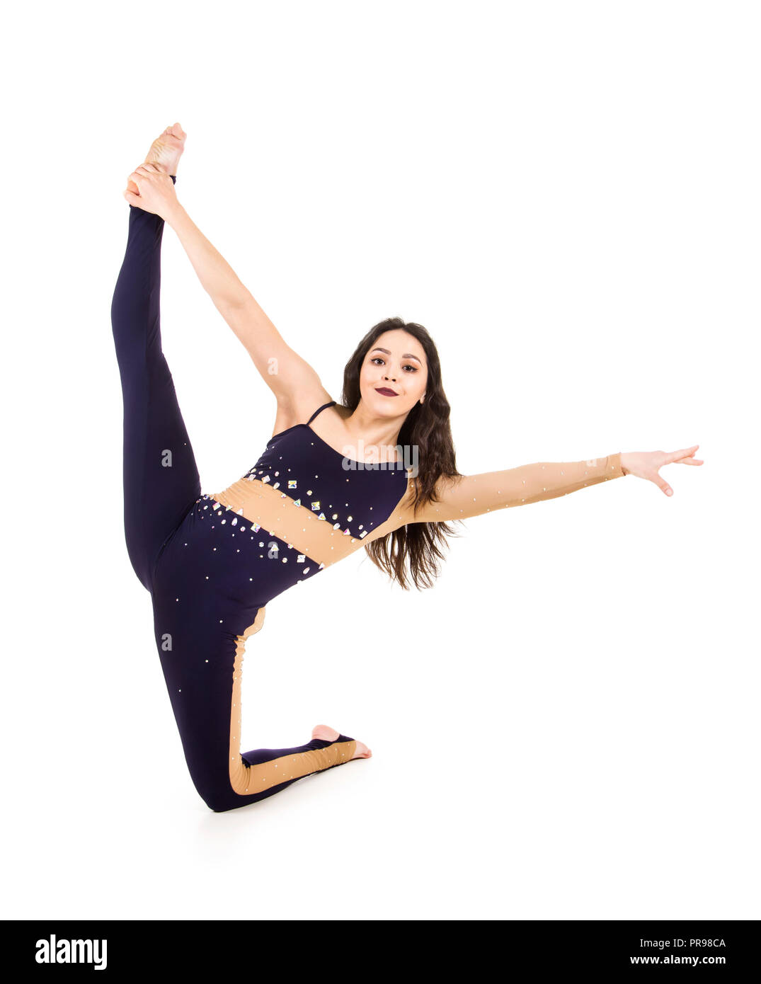 Acrobat does gymnastics, isolated image on a white background. A young circus artist in a dark suit , performs acrobatic elements Stock Photo