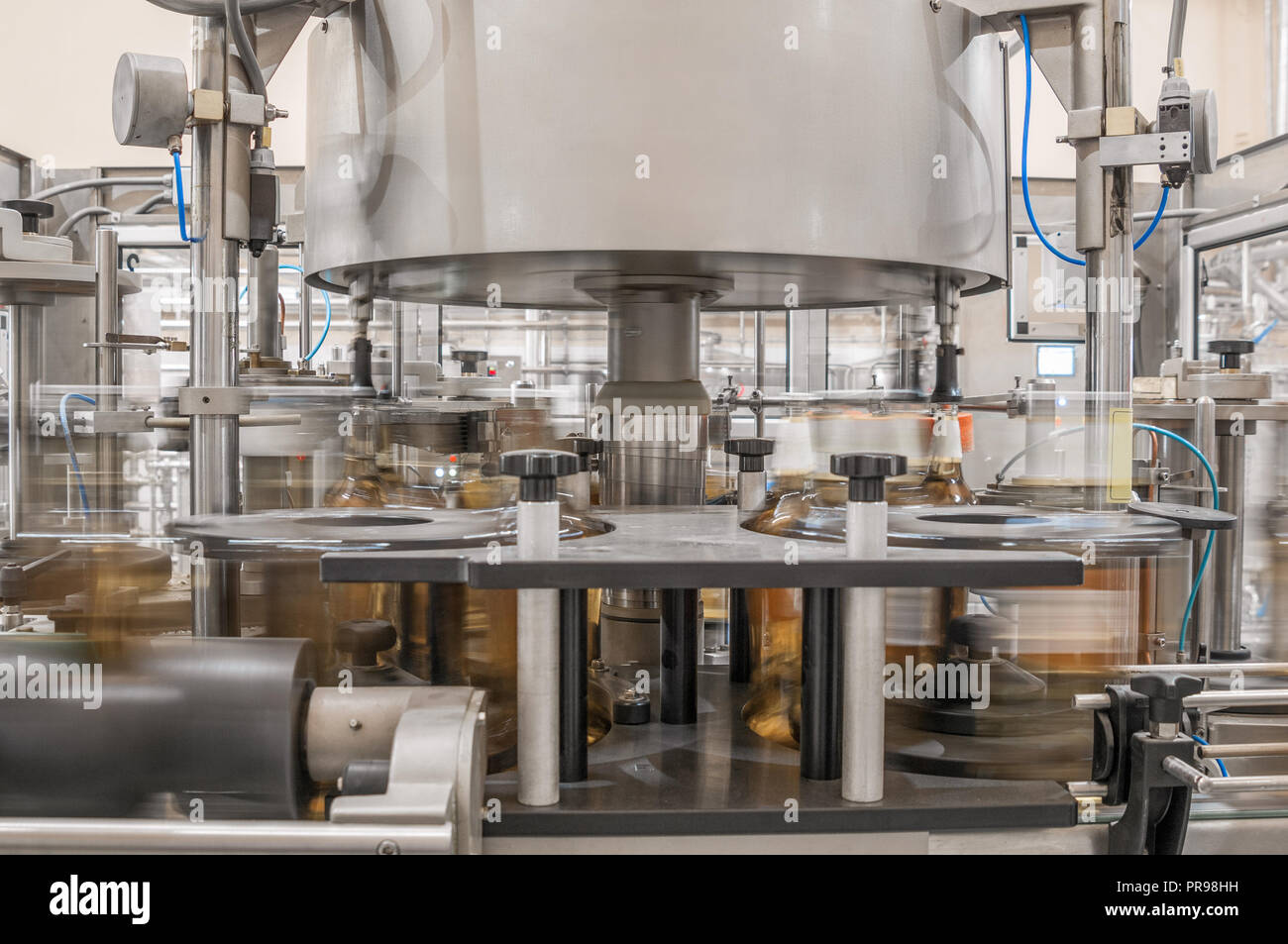 on conveyor belt filling drinks into bottles. factory shop for the