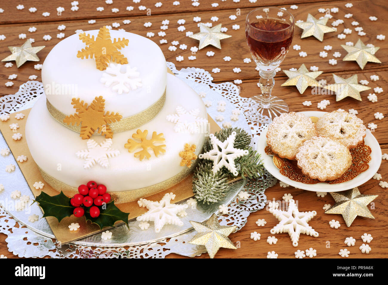 Christmas cake with mince pies and glass of sherry with snowflake ...