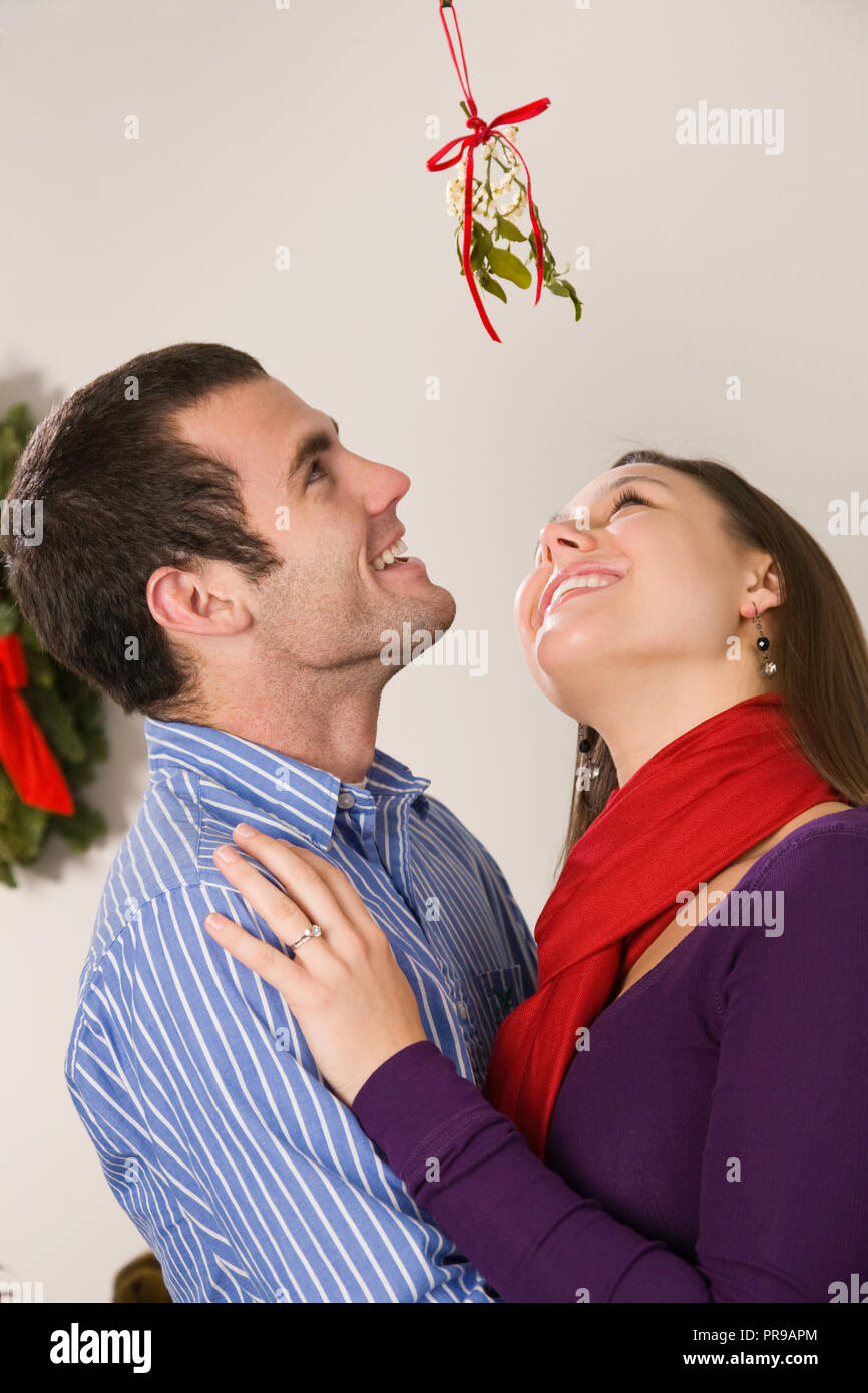 Loving young couple sharing a Christmas moment, USA Stock Photo