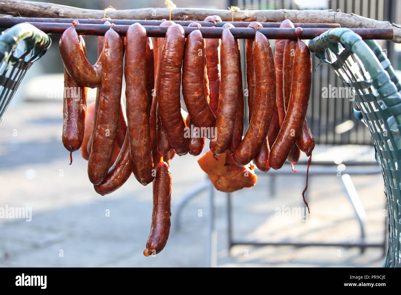 Smoked sausages hanging outside Stock Photo