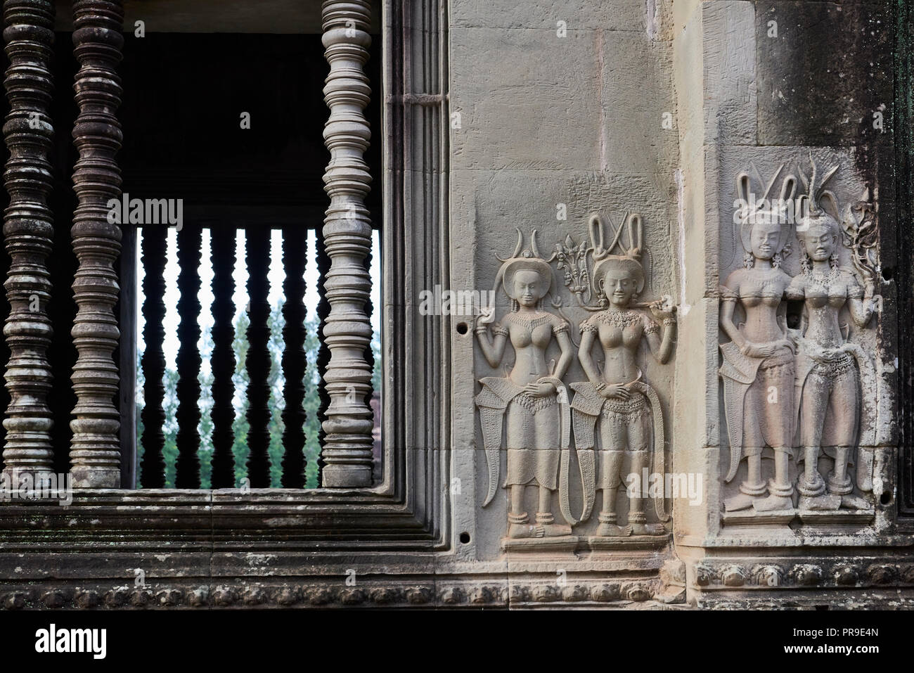 Window with dancers carved onto wall in Angkor Wat. The Angkor Wat complex, Built during the Khmer Empire age, located in Siem Reap, Cambodia, is the  Stock Photo