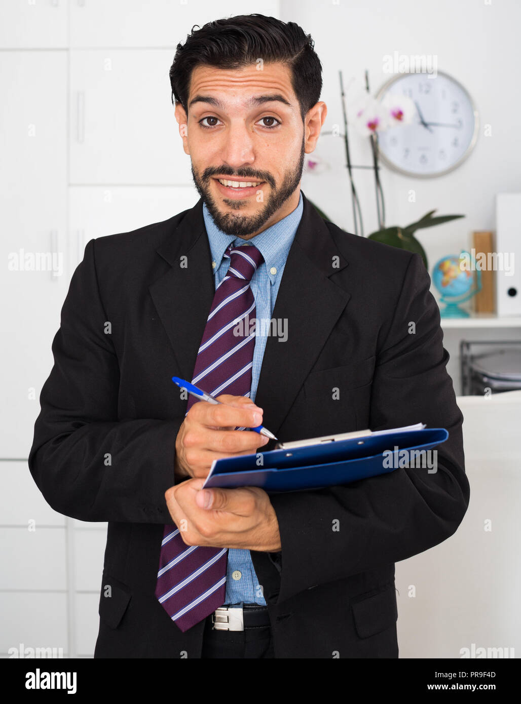 Spanish businessman is signing succesful contract in his office. Stock Photo