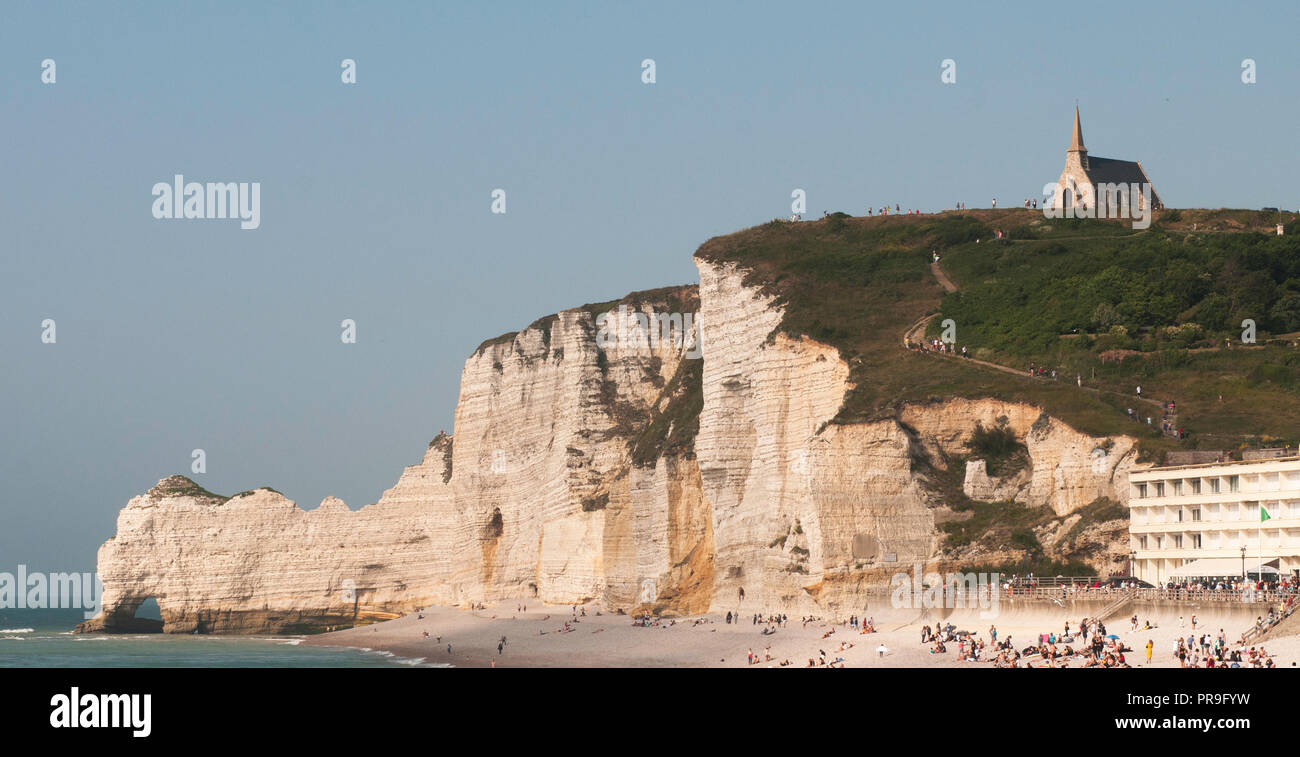 The white chalk cliffs of Etretat, France with sweeping pebble beach and natural arches, a beautiful seaside town in upper Normandy for a day trip Stock Photo