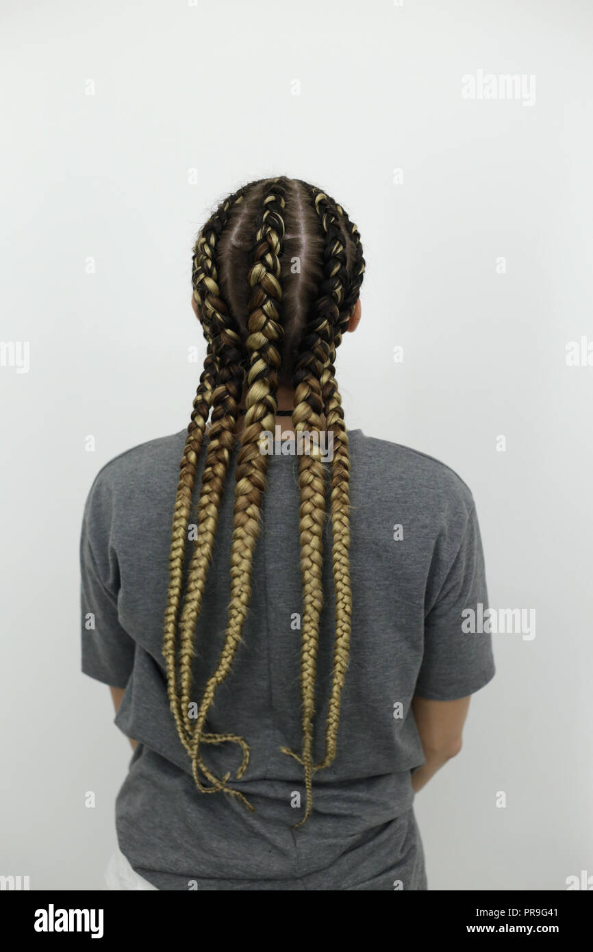 The Girl Stands With Her Back Against A Light Background