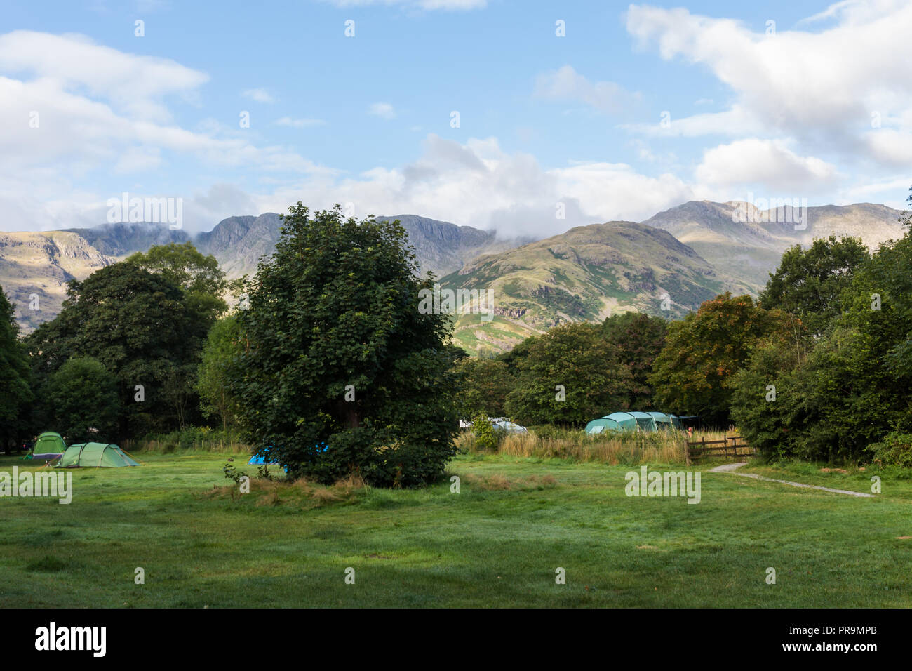 Camping in Great Langdale with view of The Band and Bowfell, Lake District, Cumbria, England. Stock Photo