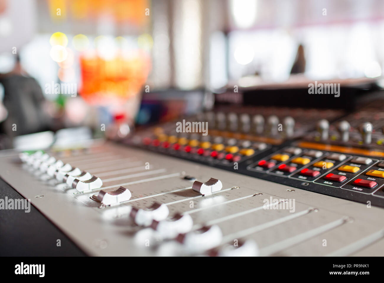 control Fader. Mixing console of light equipment operator at the concert. Sound recording studio mixing desk with engineer or music producer Stock Photo
