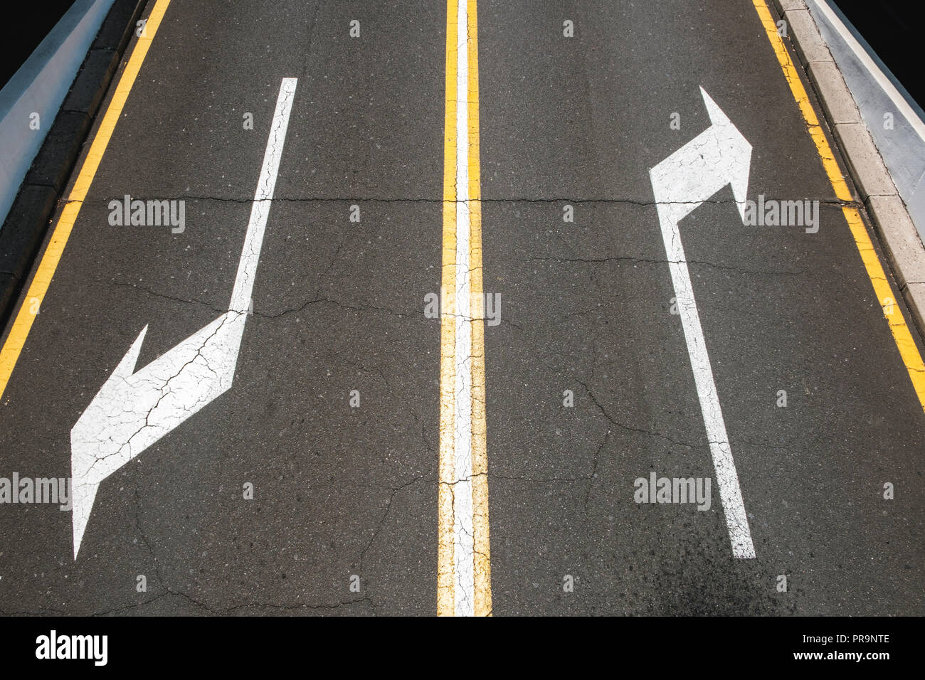 left / right, direction arrows on asphalt road - Stock Photo