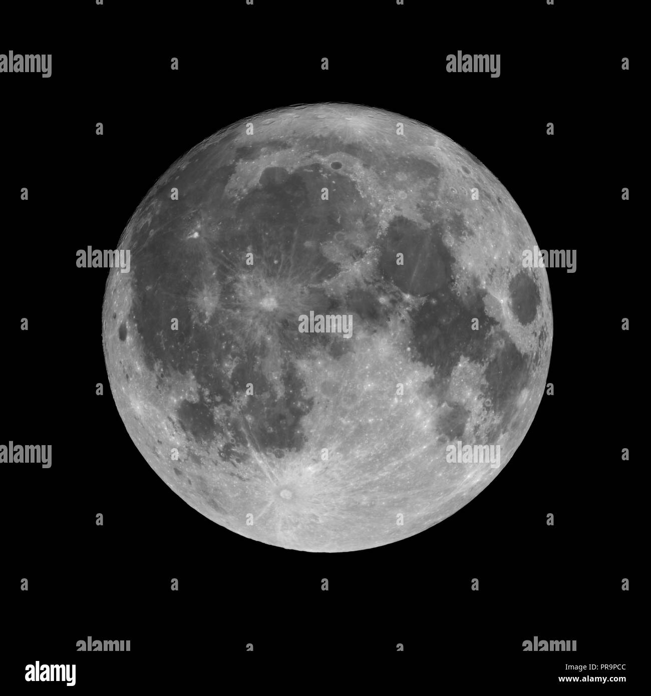 Full moon isolated on black night sky background. 99,7% of Moon visible just before full moon phase Stock Photo