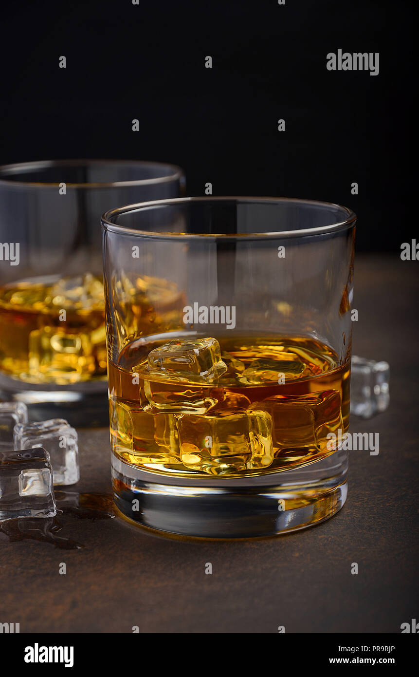 Glass of whiskey with ice on the old rusty background Stock Photo