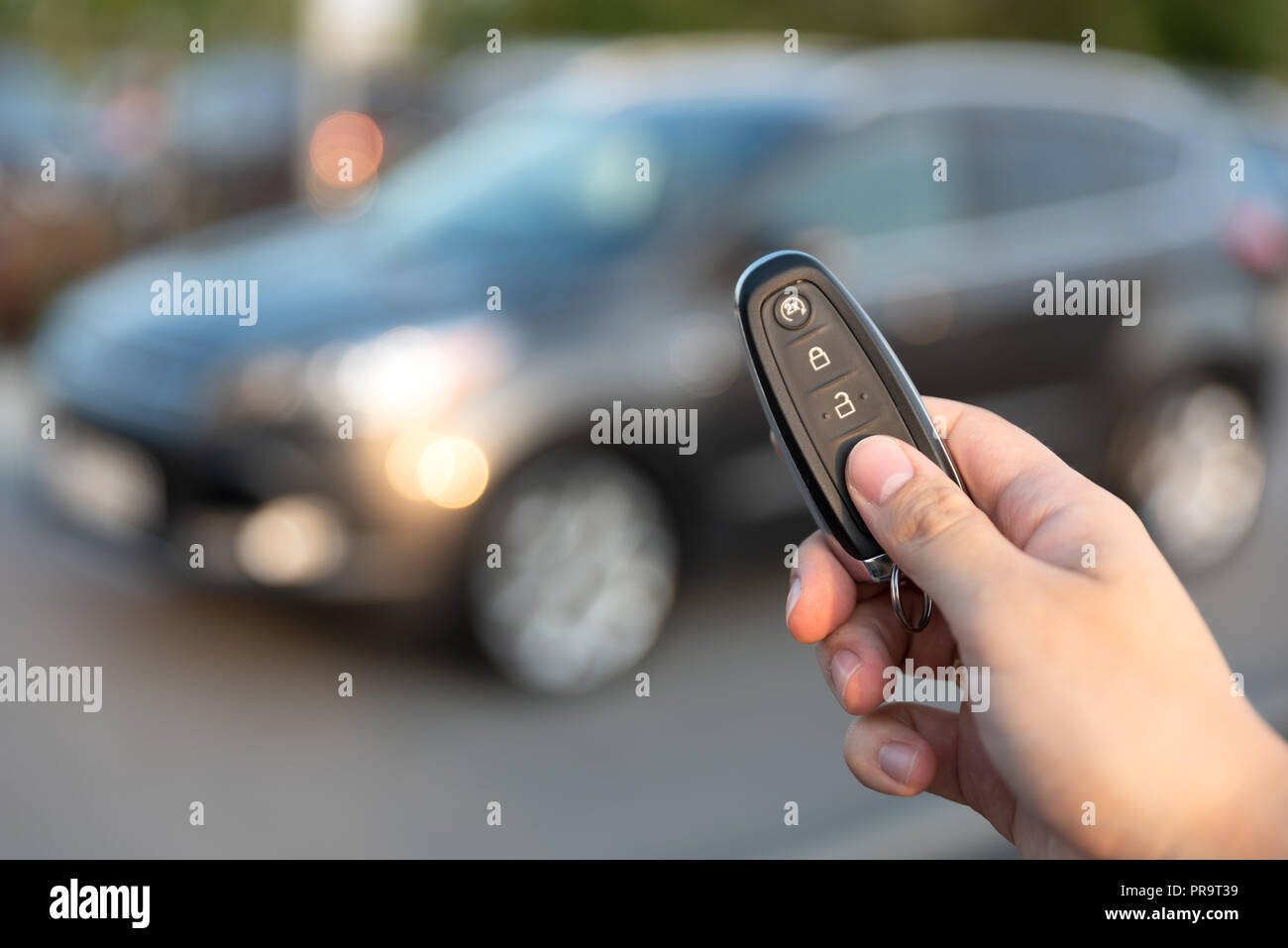 Man opening car with the control remote key. Keyless car system remote control Stock Photo