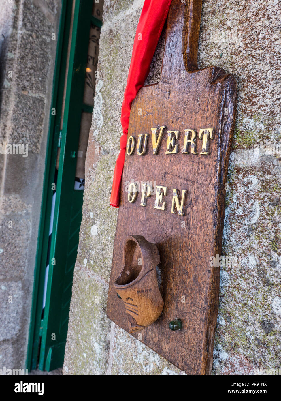 Rustic French 'OUVERT' open bi-lingual sign with clog outside a Dutch Bakery patisserie Boulanger in old town Ville Close Concarneau Brittany France Stock Photo