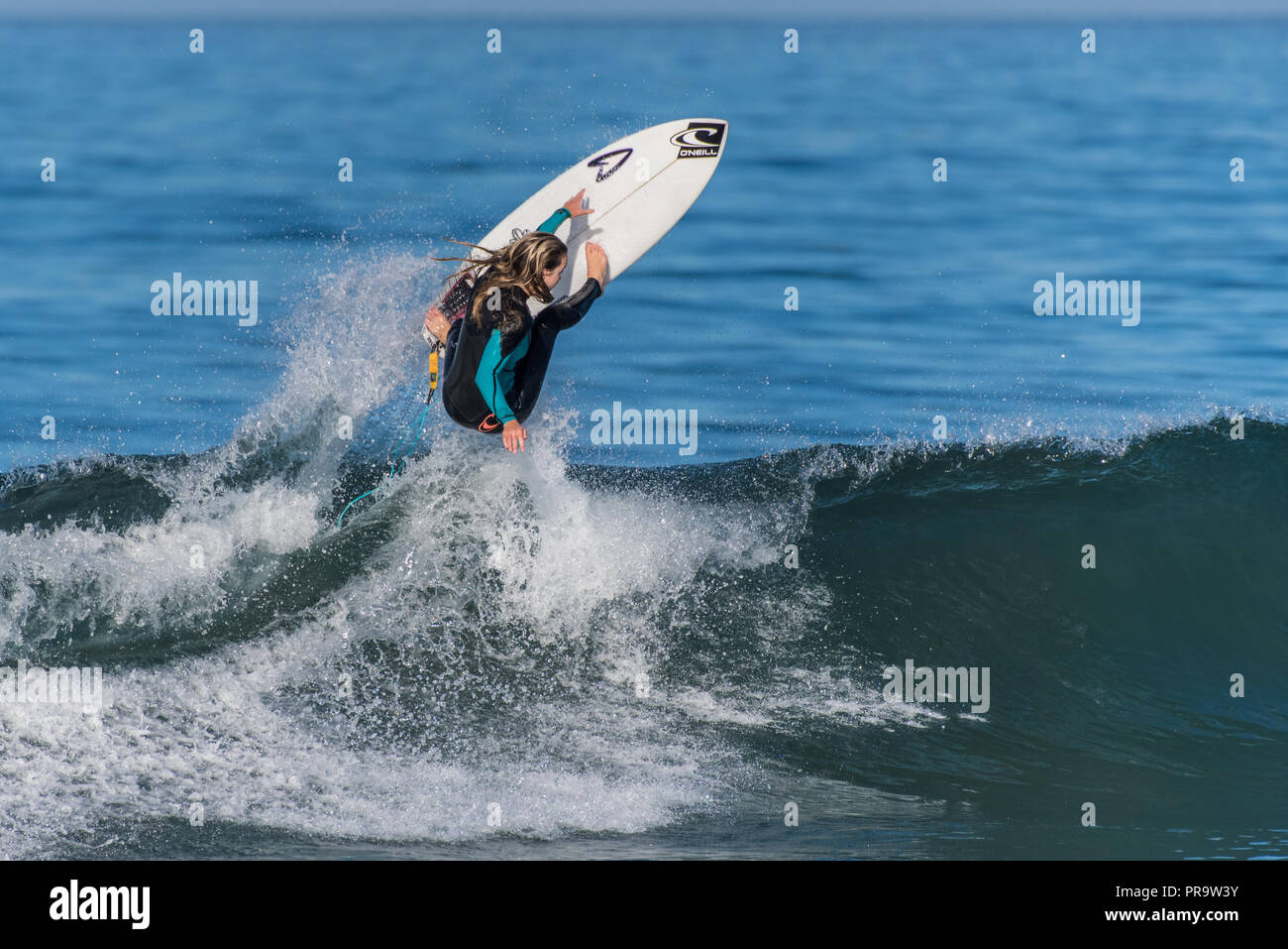 Telented female surfer launched an air on a clean wave pushed by Hurricane Rosa at Ventura's Surfers Knoll on September 30, 2018 in California. Stock Photo