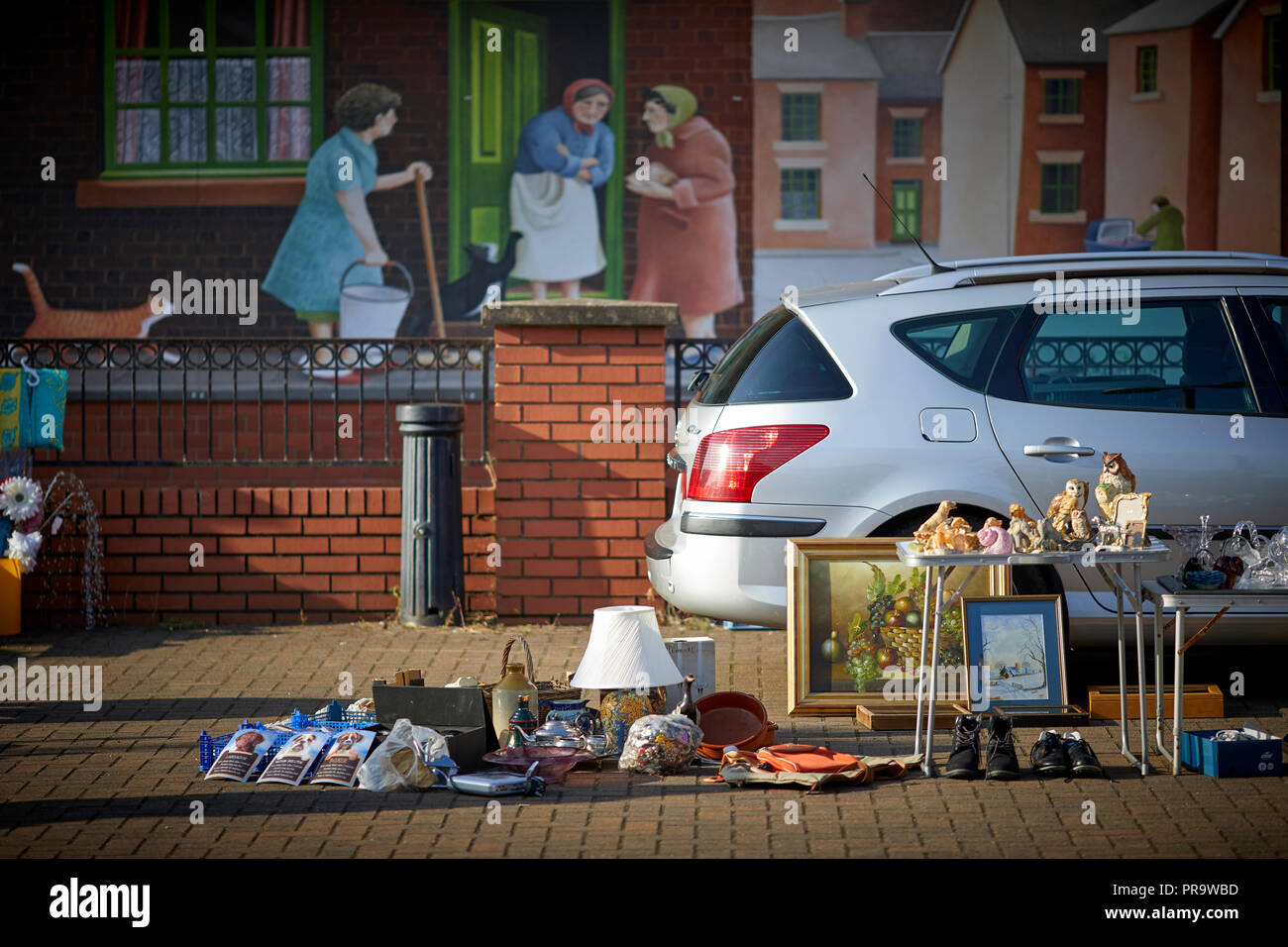 Car boot sale at the market hall with terraced house mural behind Stoke