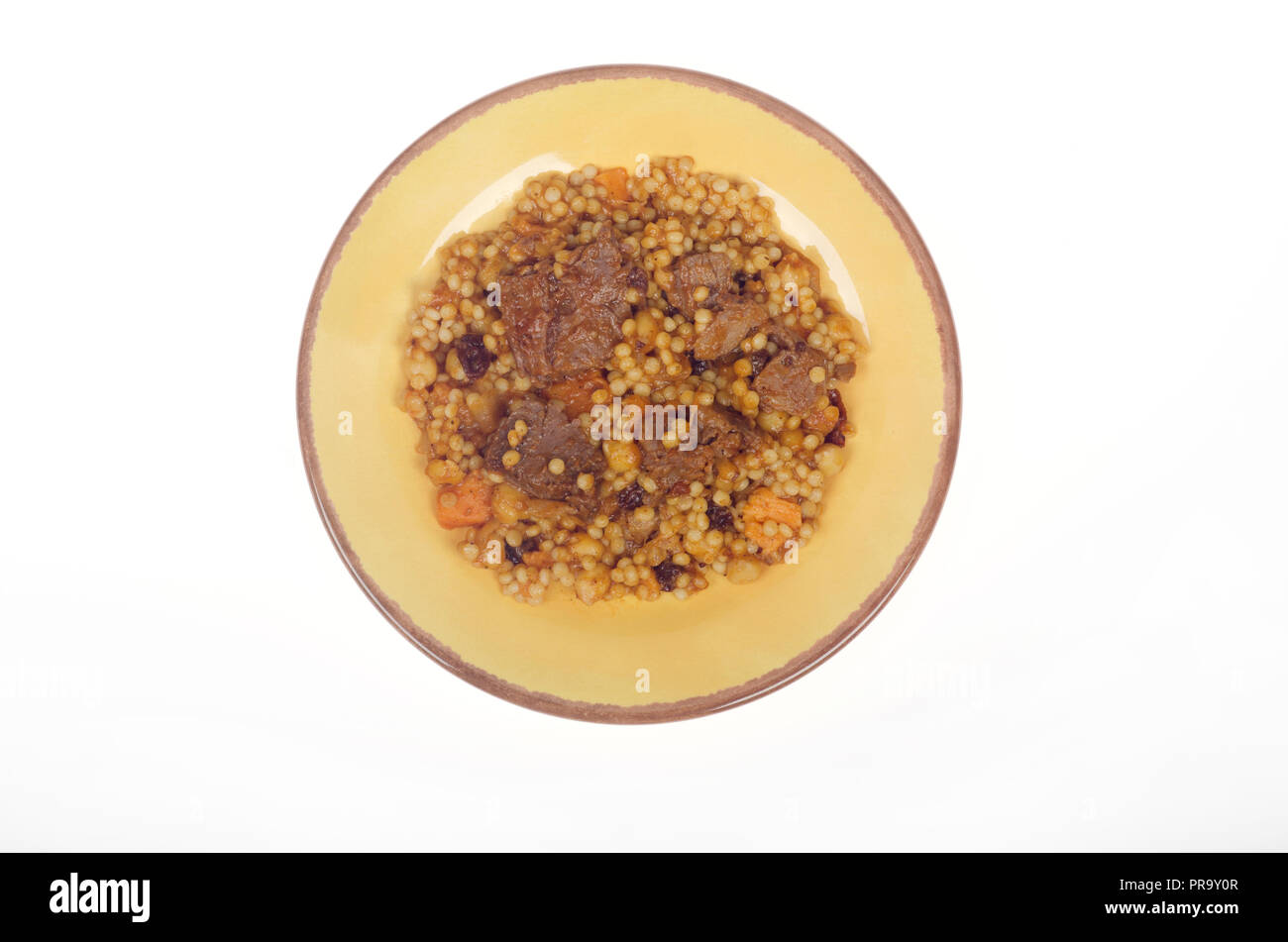 Plate of Morrocan style beef with couscous, carrots and chick peas from above Stock Photo