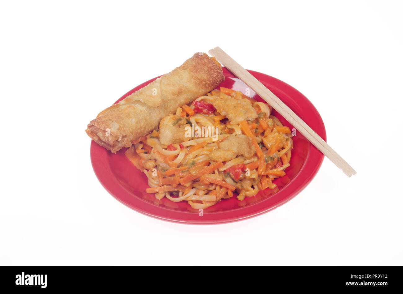 Chicken Pad Thai with a vegetable egg roll and chop sticks on red plate Stock Photo