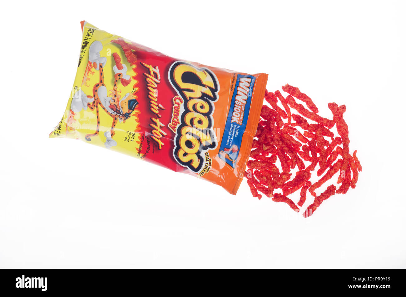 Opened bag of Cheetos Crunchy Flamin’ Hot snacks with some pouring out onto white background Stock Photo