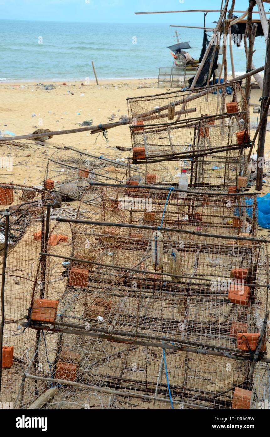 Square Box Fishnets Wire mesh square box fishing nets and boats at seaside beach village ...