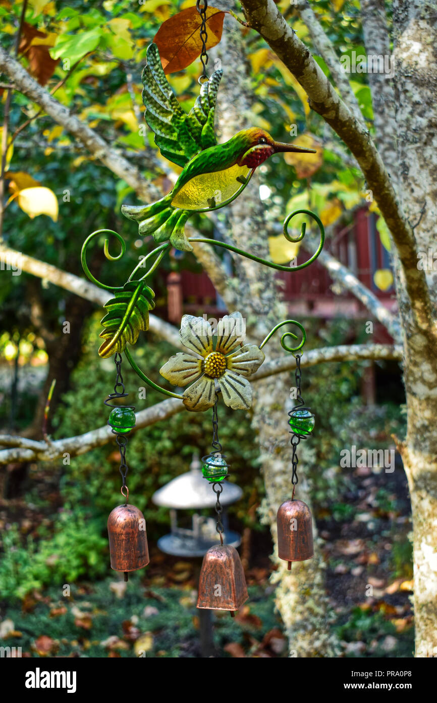 Hummingbird wind chime hanging in a tree Stock Photo