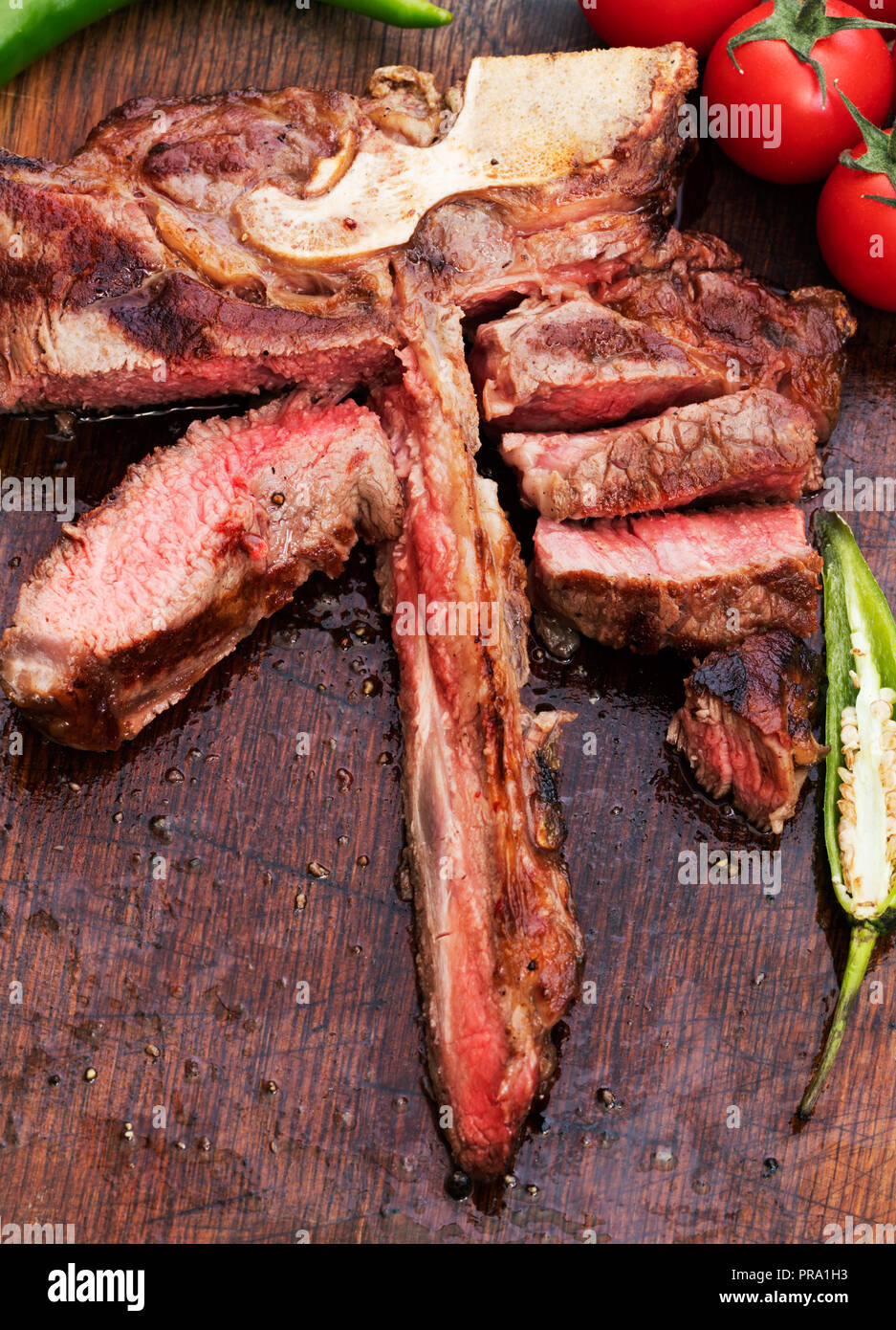 leftover of medium roasted porterhouse beef steak on wooden background