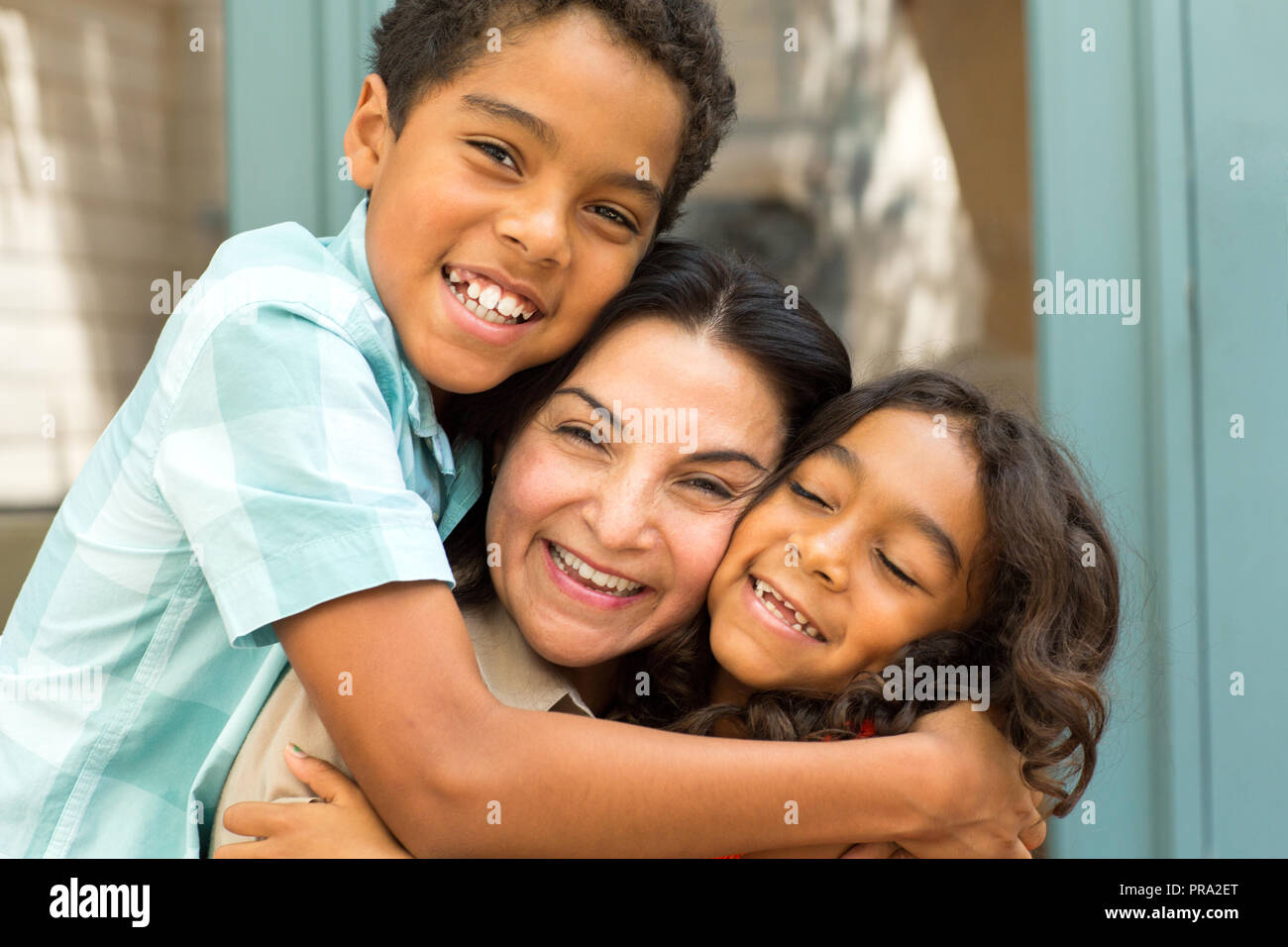 Happy Hispnaic mother laughing and talking with her children. Stock Photo